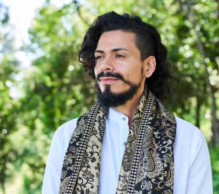 Francisco, black long hair and beard with a white shirt and a scarf