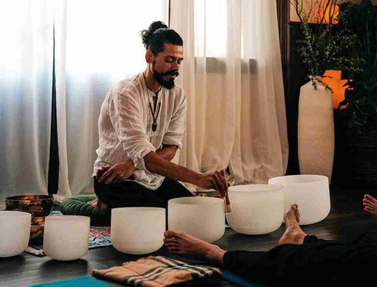 Francisco doing sound healing on white bowls