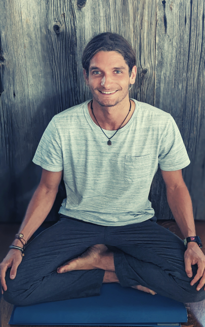 Kolin Purcell in a seated meditation posture, smiling